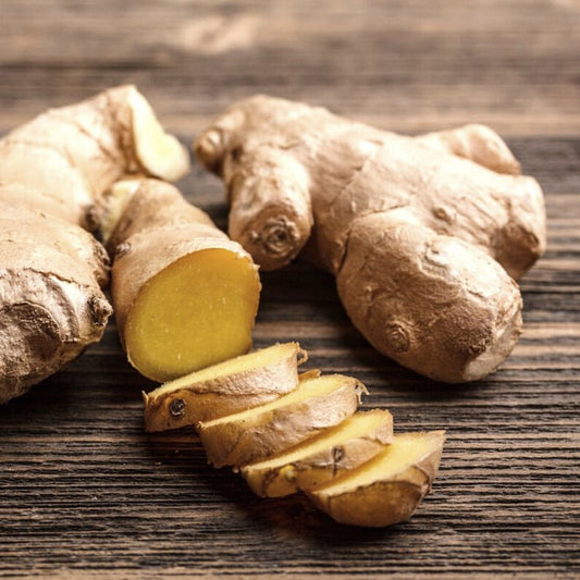 Fresh ginger root on a wooden surface