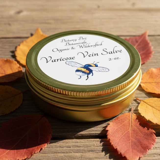 Gold-lidded jar of Botany Bee Botanicals Varicose Vein Salve on a textured surface