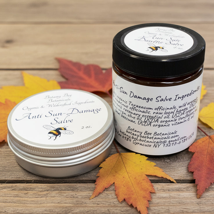 Two jars of anti sun-damage salve on a wooden surface