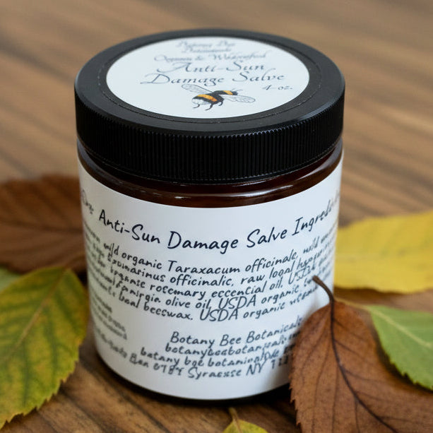 Jar of Botany Bee Botanicals Anti-Sun-Damage Salve on a wooden surface