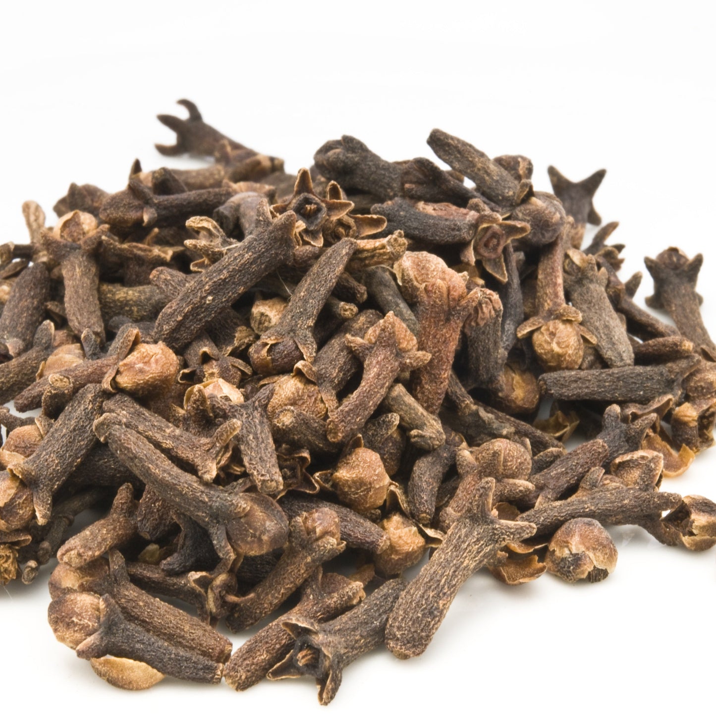 Pile of dried cloves on a white background