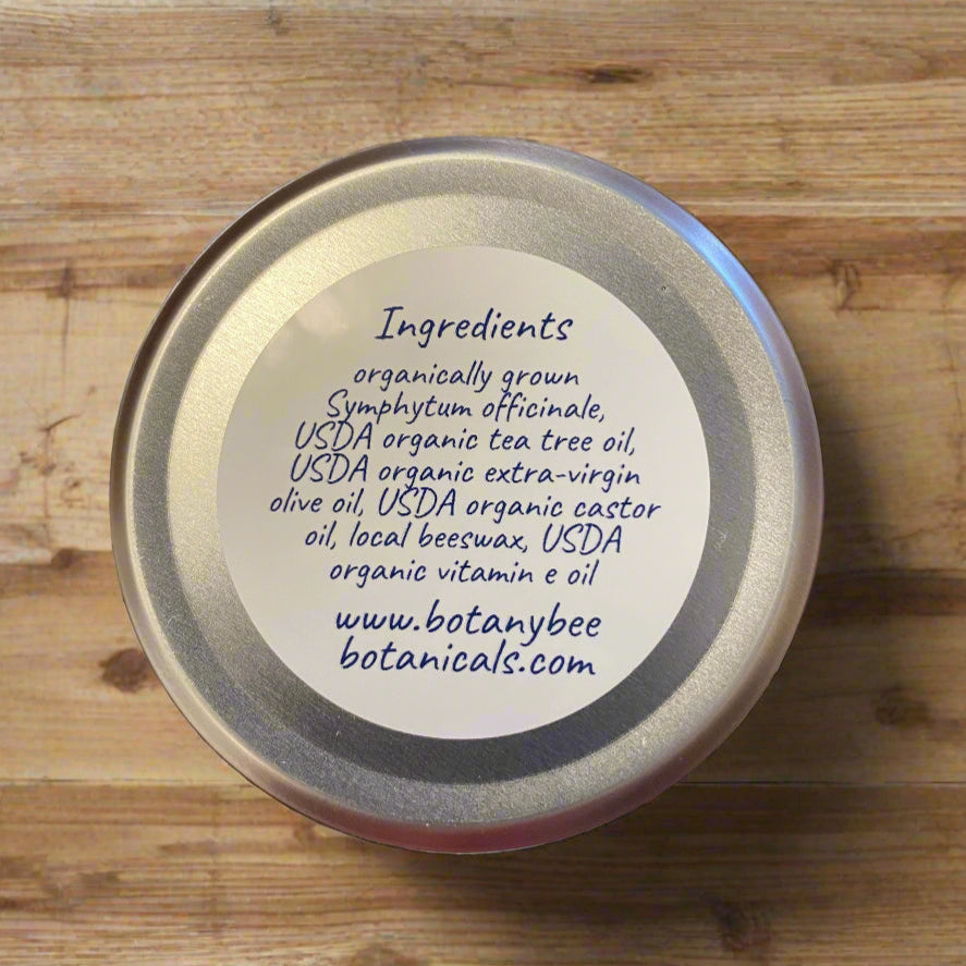Container of Comfrey Tea Tree Salve and Ingredients