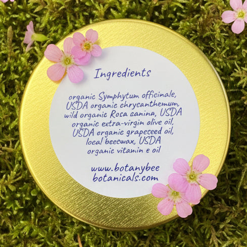 Gold container lid with white label listing ingredients on a wooden surface