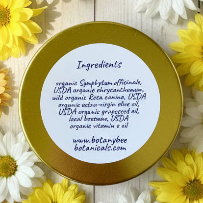 Gold container lid with white label listing ingredients on a wooden surface