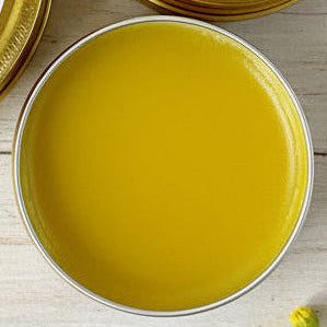 An open tin of salve