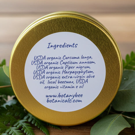 Gold container lid with white label listing ingredients 