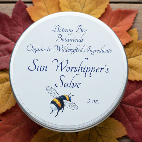 Tin labeled 'Sun Worshipper's Salve' on a wooden surface