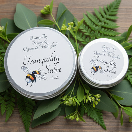 Two jars of Tranquility Salve on a bed of green leaves