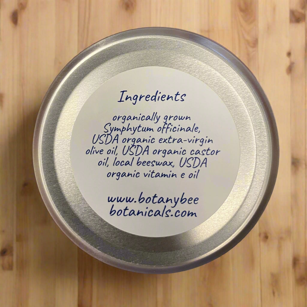 Silver lid with a label listing ingredients and a website URL on a brown background