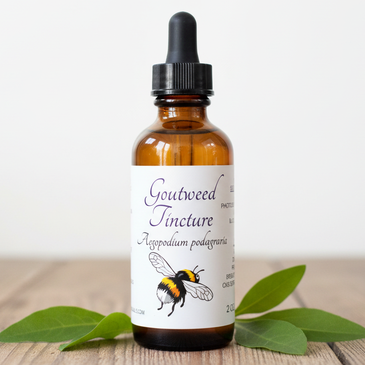 Label for Goutweed Tincture with bee illustration and text details.